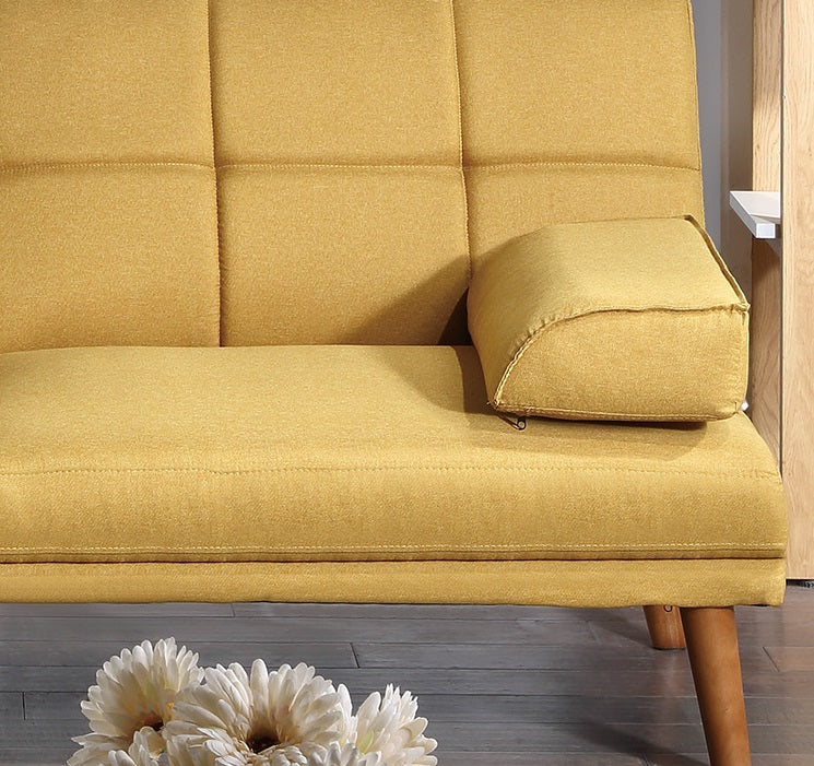 Mustard yellow tufted sofa with a single decorative cushion