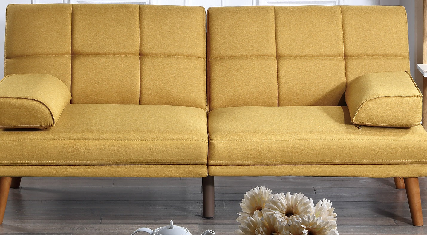 Tufted mustard yellow fabric sofa with plush seat cushions and square throw pillows