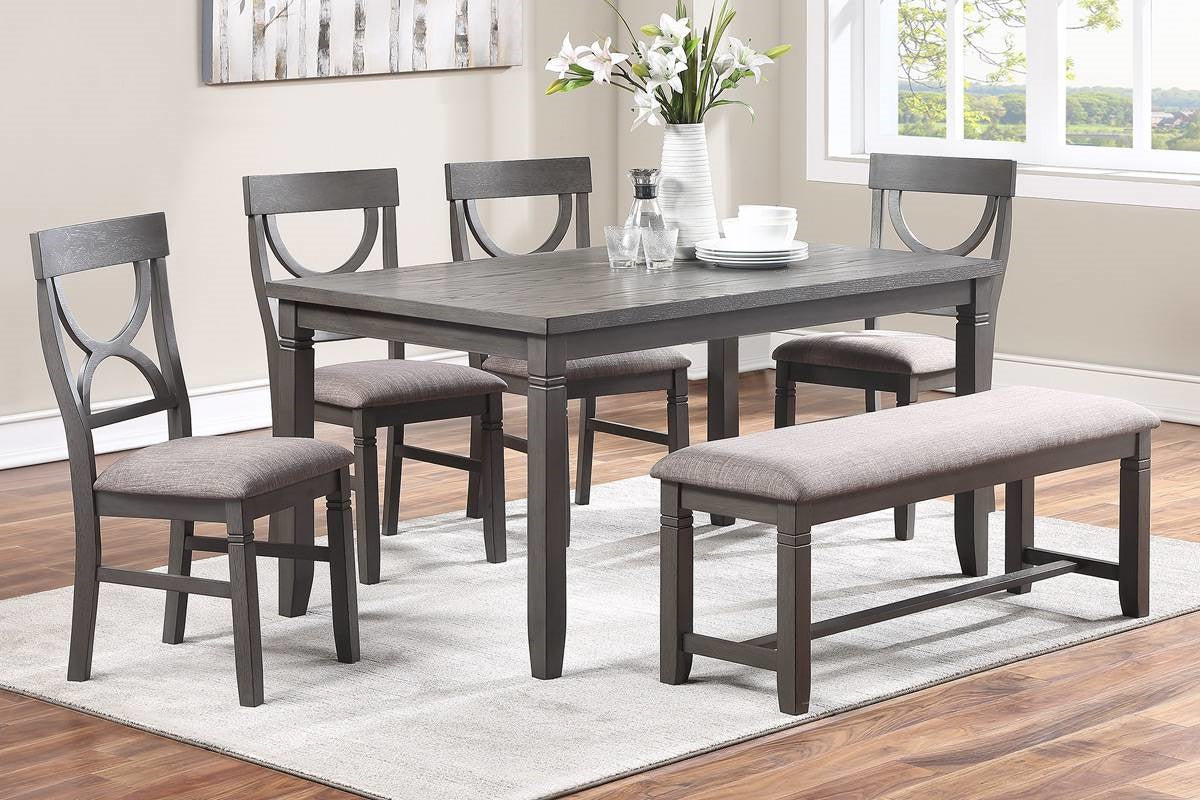 Dark grey wood dining table with four chairs and a bench