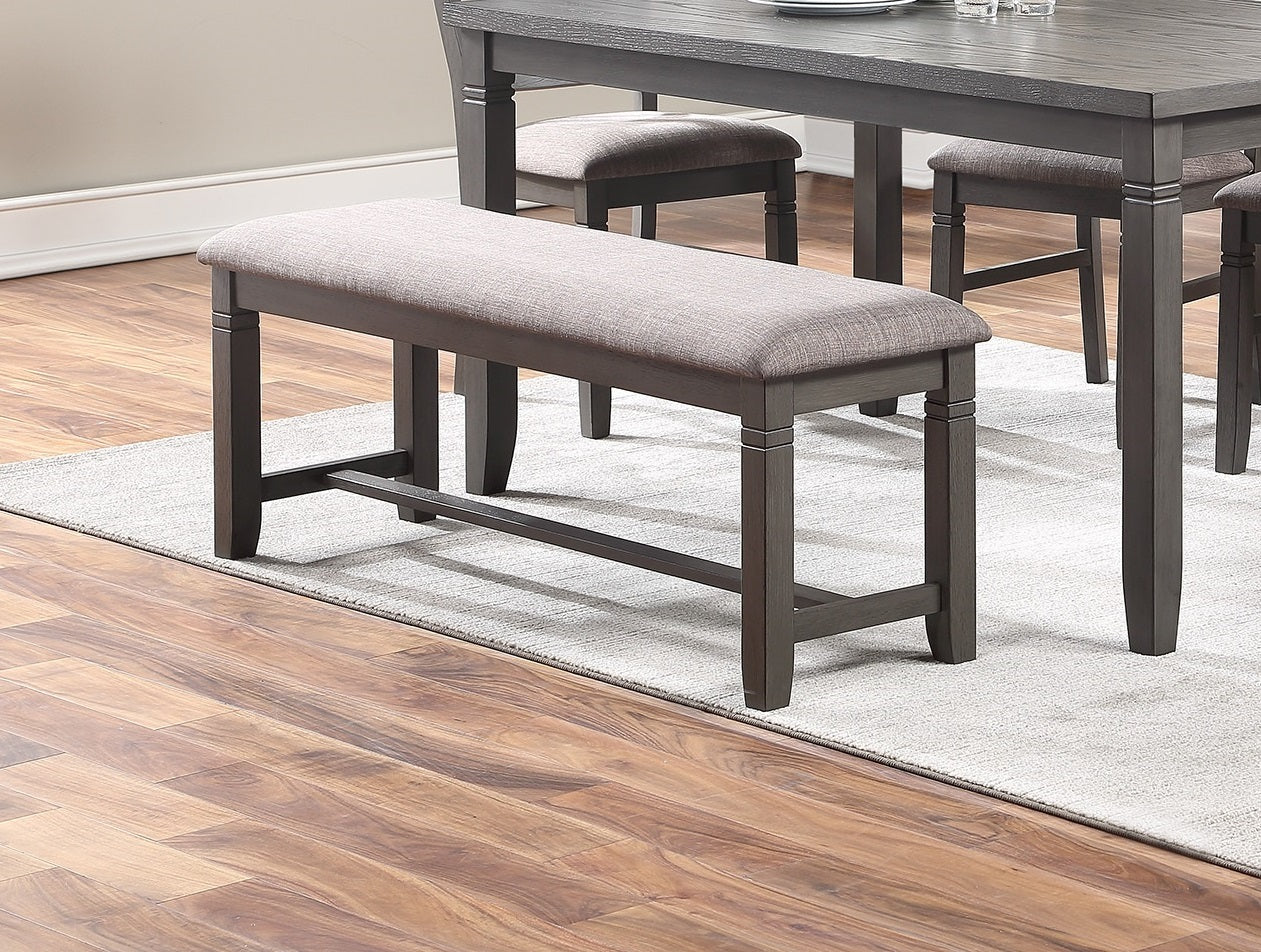 Gray upholstered dining bench with dark wood frame and tapered legs