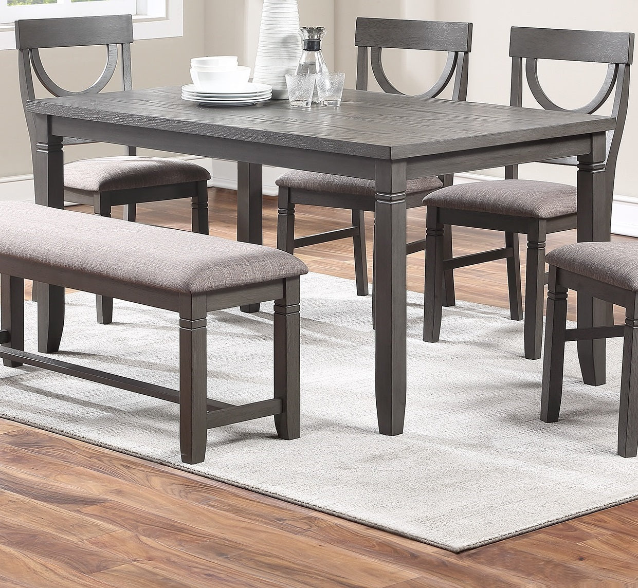 Gray farmhouse dining table with upholstered bench and chairs