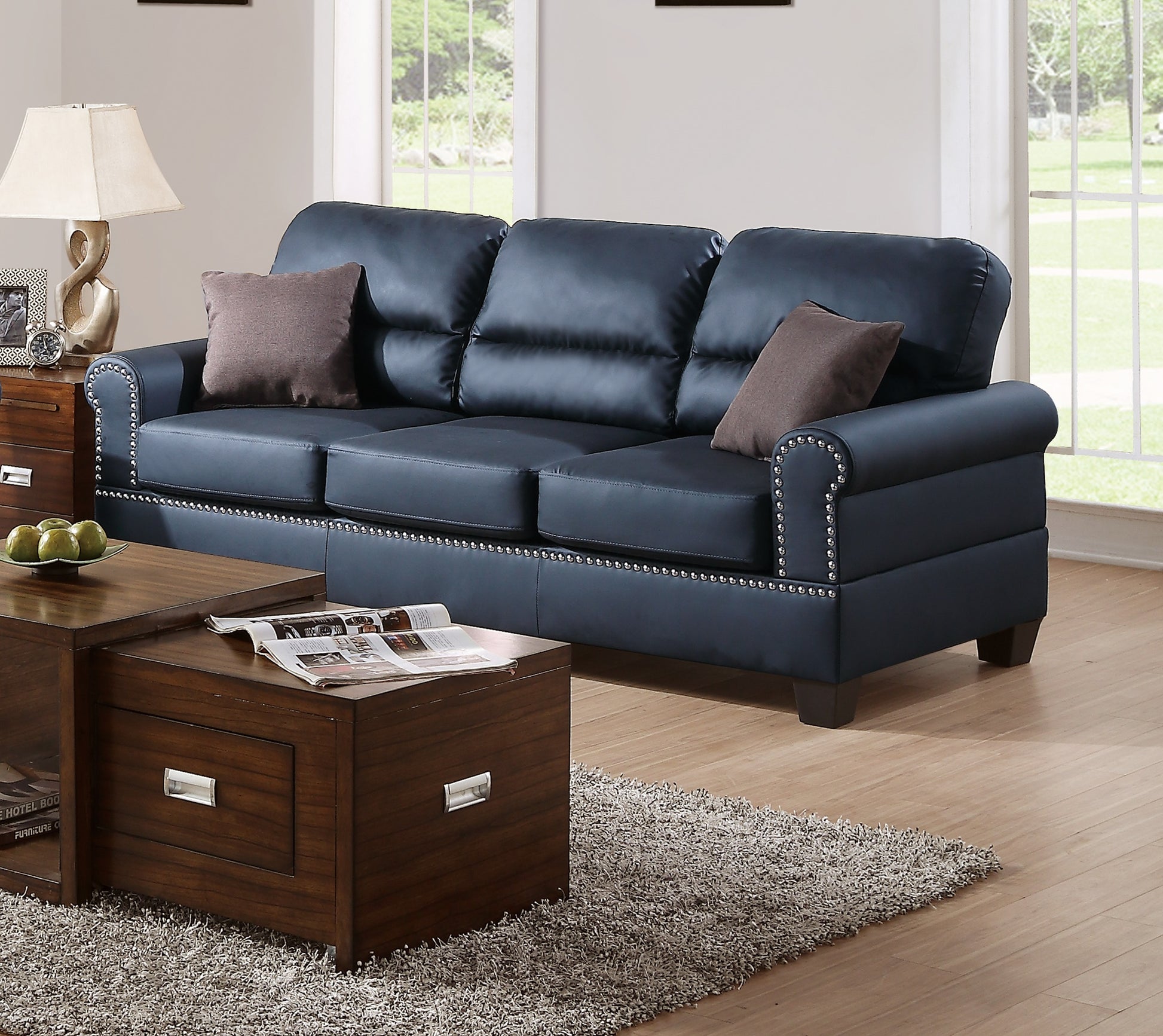 Dark blue leather sofa with studding detail perfect for modern living rooms