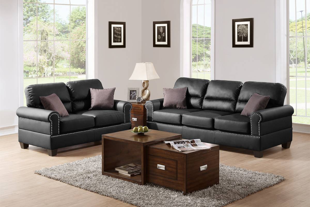 Black leather sofa with studded accents and plush throw pillows
