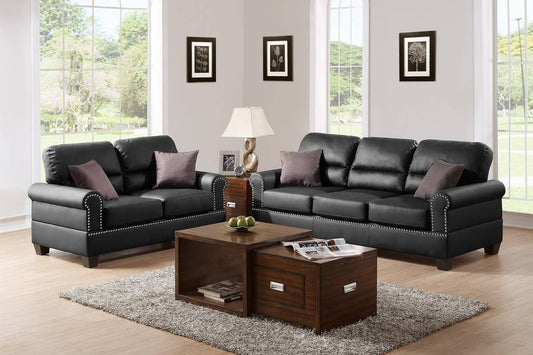 Black leather sofa with studded accents and plush throw pillows