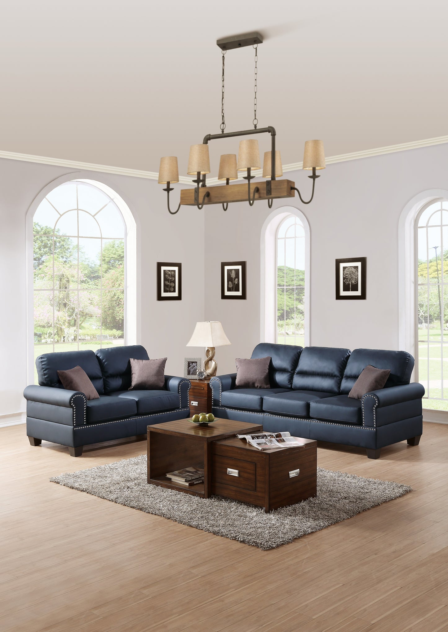 Navy blue faux leather sofa set with silver nailhead trim and plush cushions