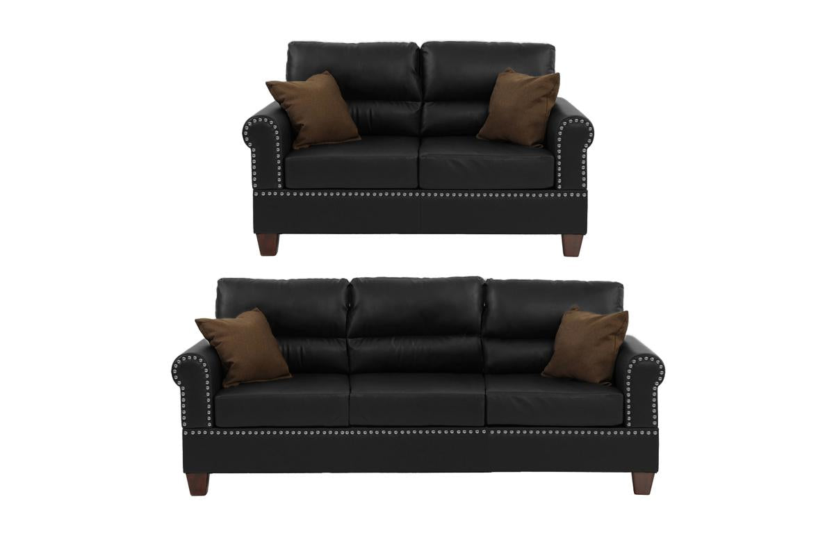 Black faux leather loveseat with studded trim and brown throw pillows