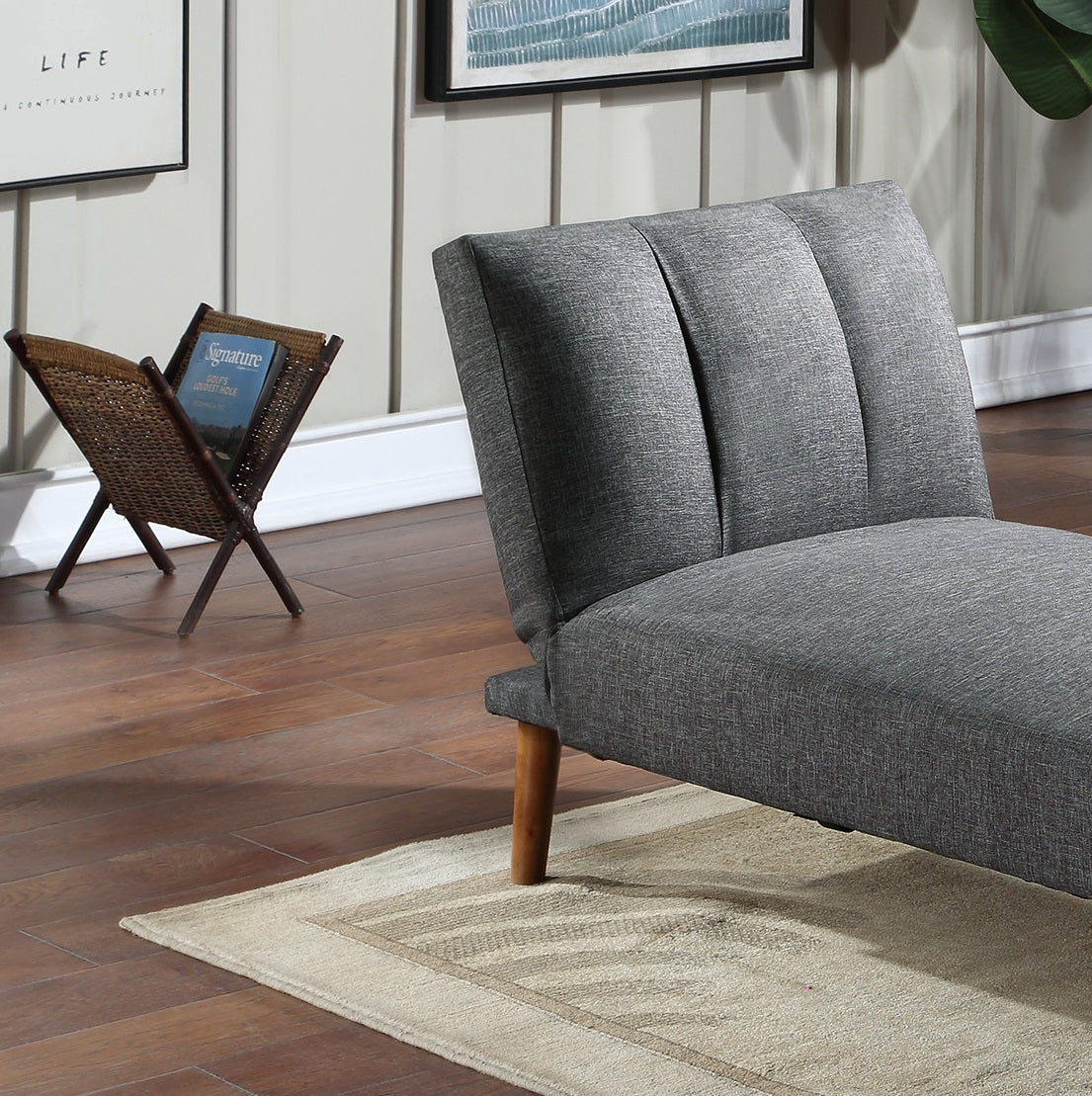 Grey upholstered accent chair with tufted back and wooden legs