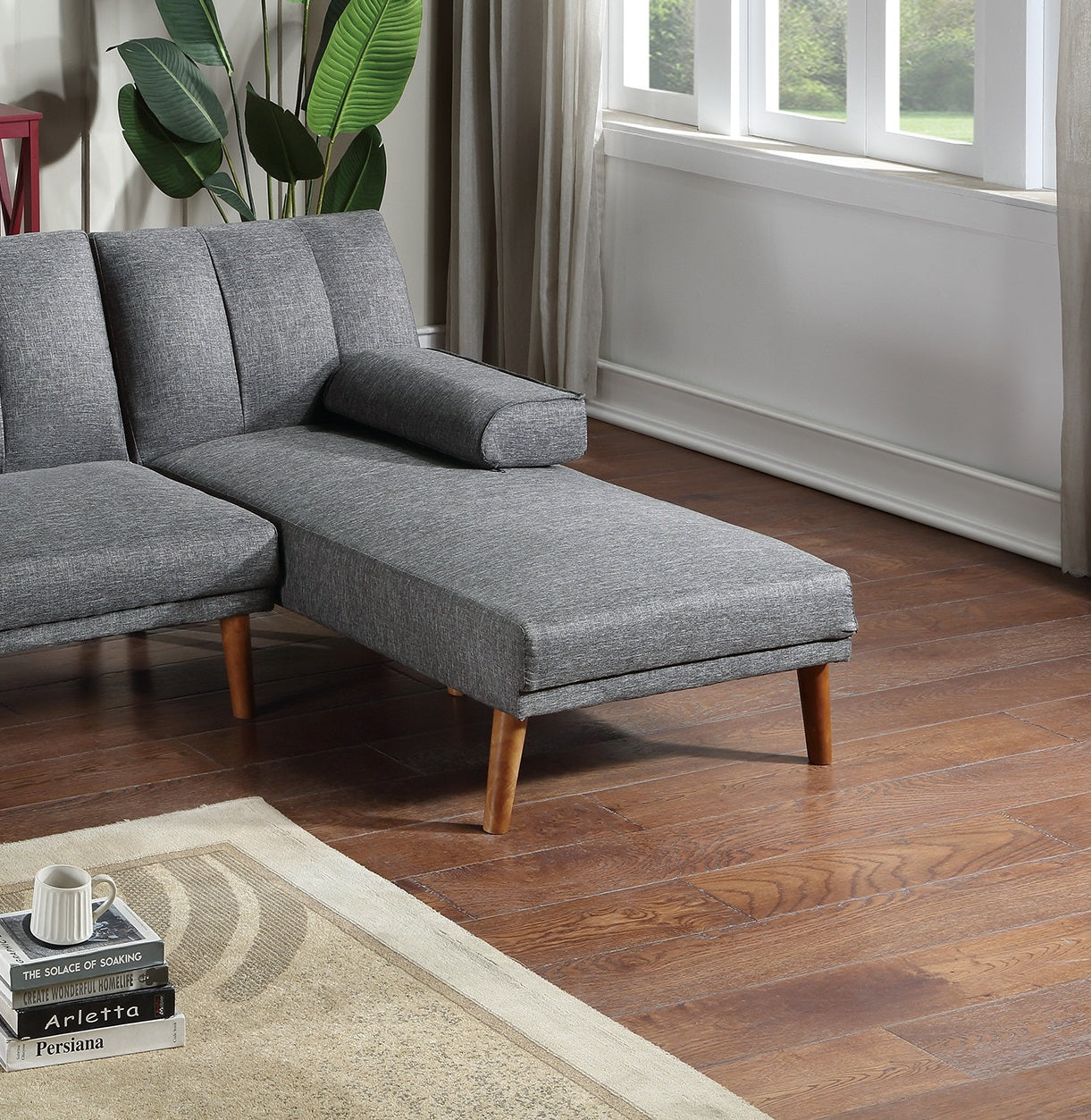 Gray upholstered sectional sofa with wooden legs and a detached chaise lounge