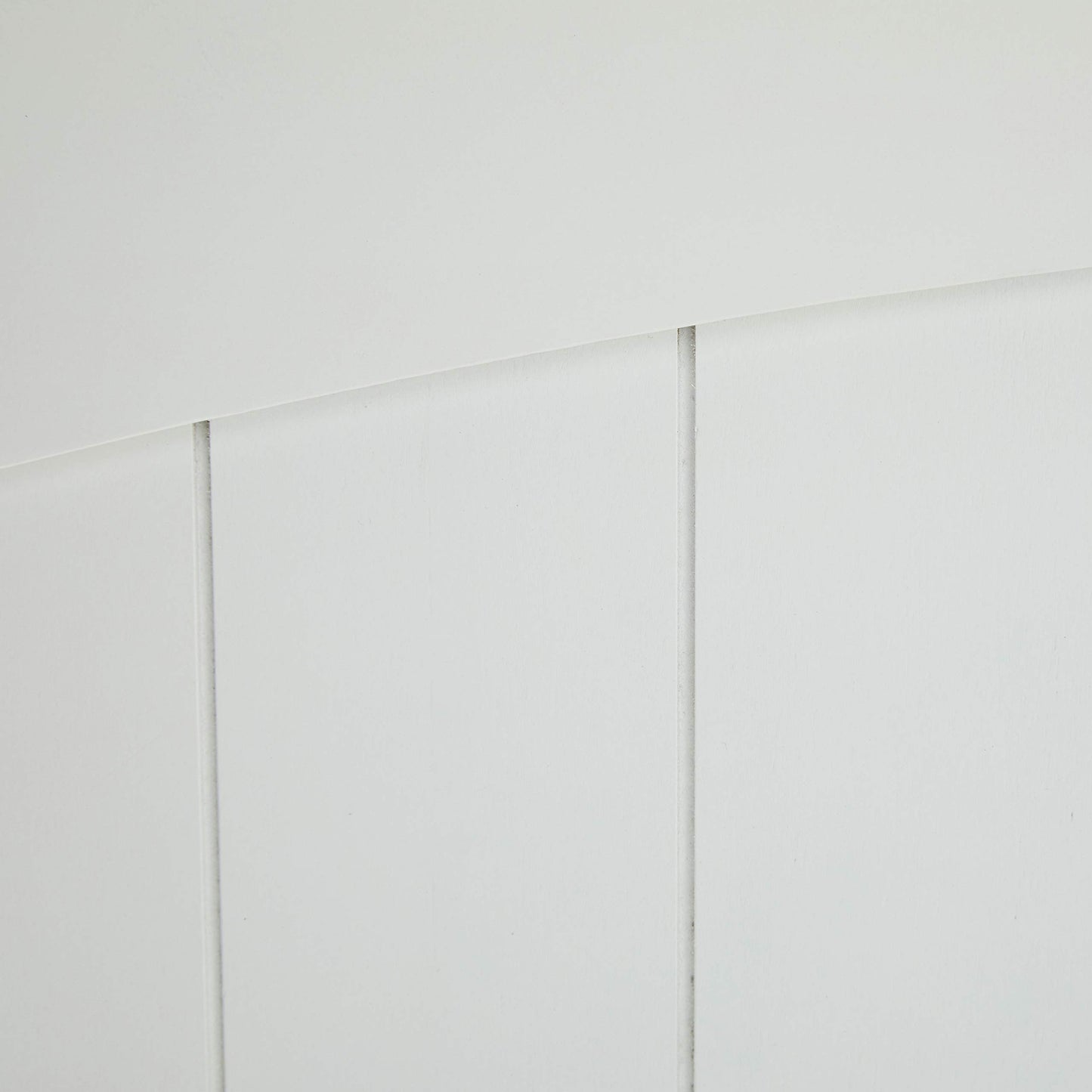 Closeup of white beadboard paneling with subtle grooves perfect for DIY projects