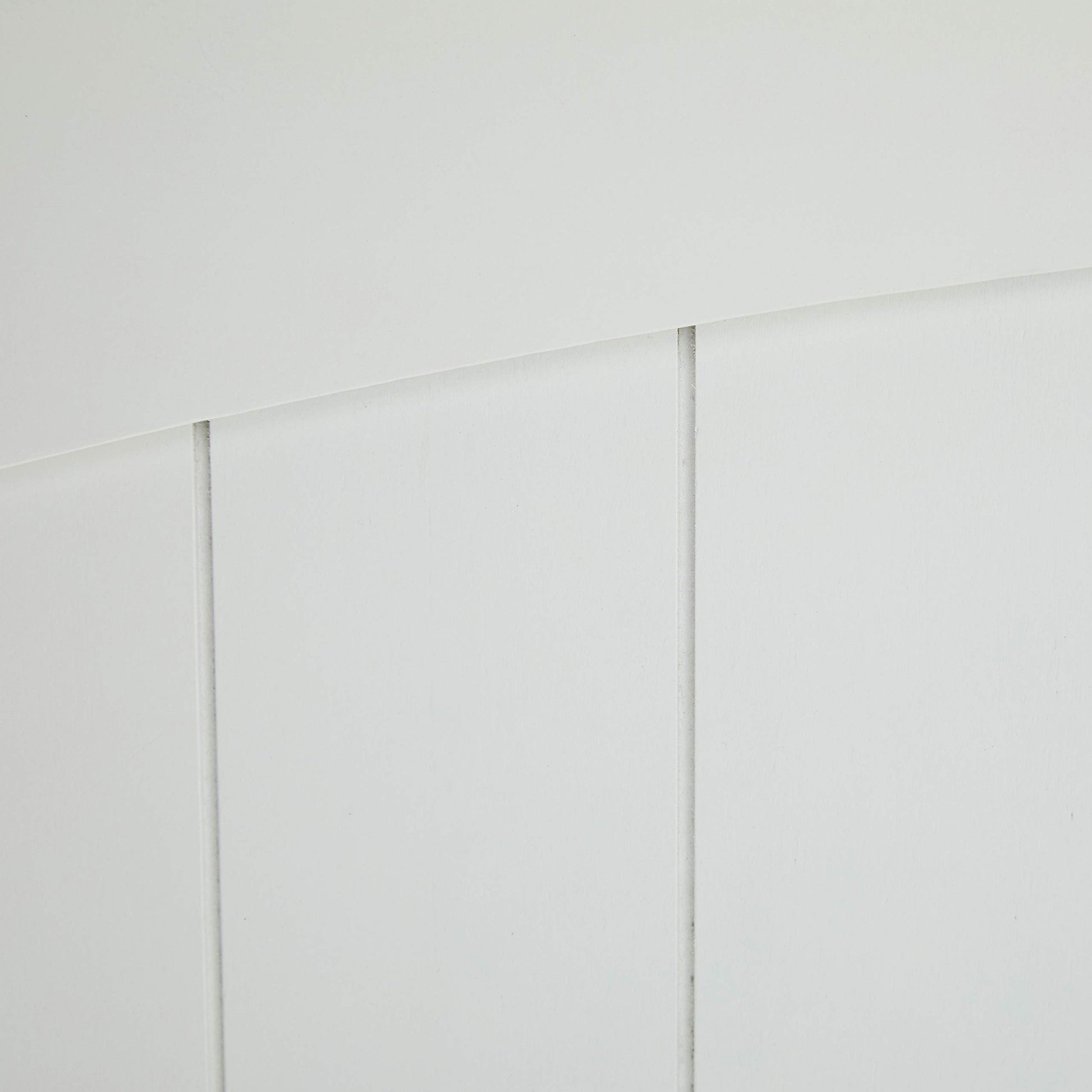 Closeup of white beadboard paneling with subtle grooves perfect for DIY projects