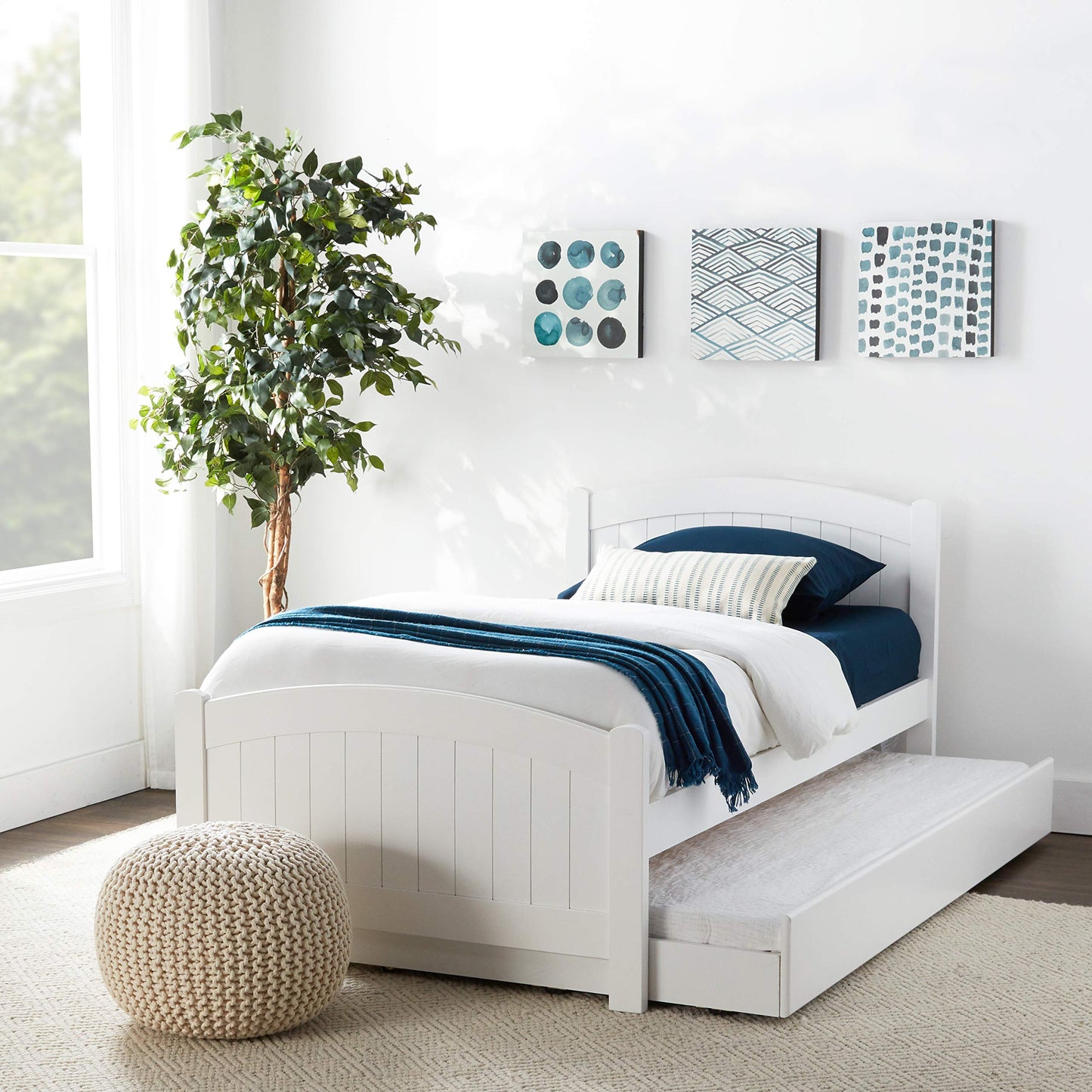 White wooden twin bed with pullout trundle perfect for guest rooms