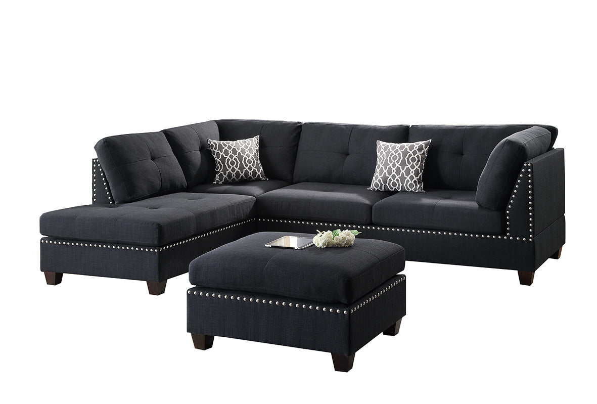 Charcoal grey fabric sectional sofa with tufted cushions and silver stud detailing