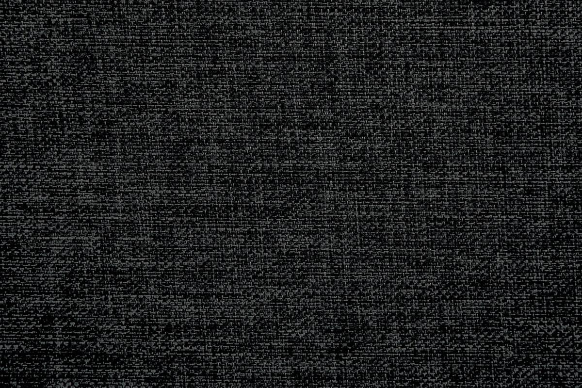 Closeup textured black upholstery fabric with a subtle weave pattern