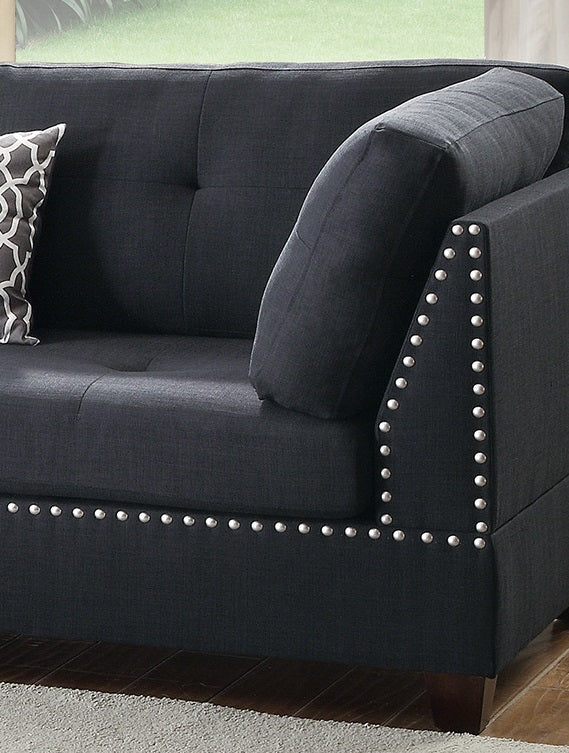 Dark gray linen sofa with tufted back and decorative nailhead trim