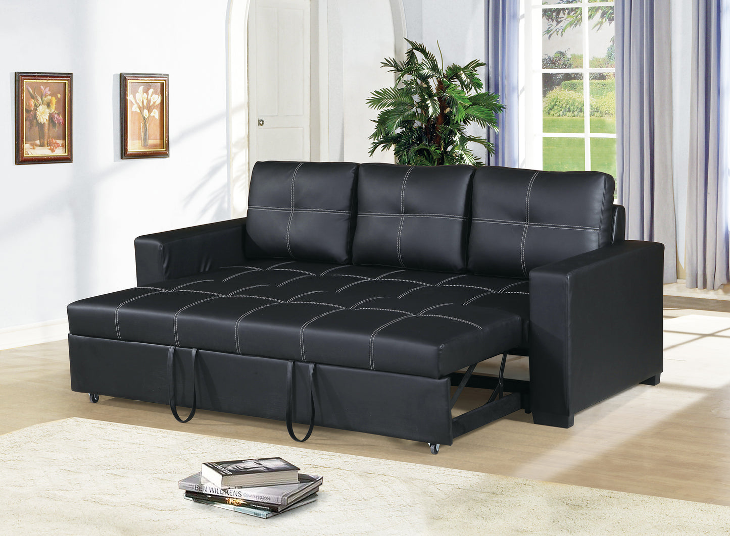 Black faux leather sofa bed with white stitching and pullout ottoman function