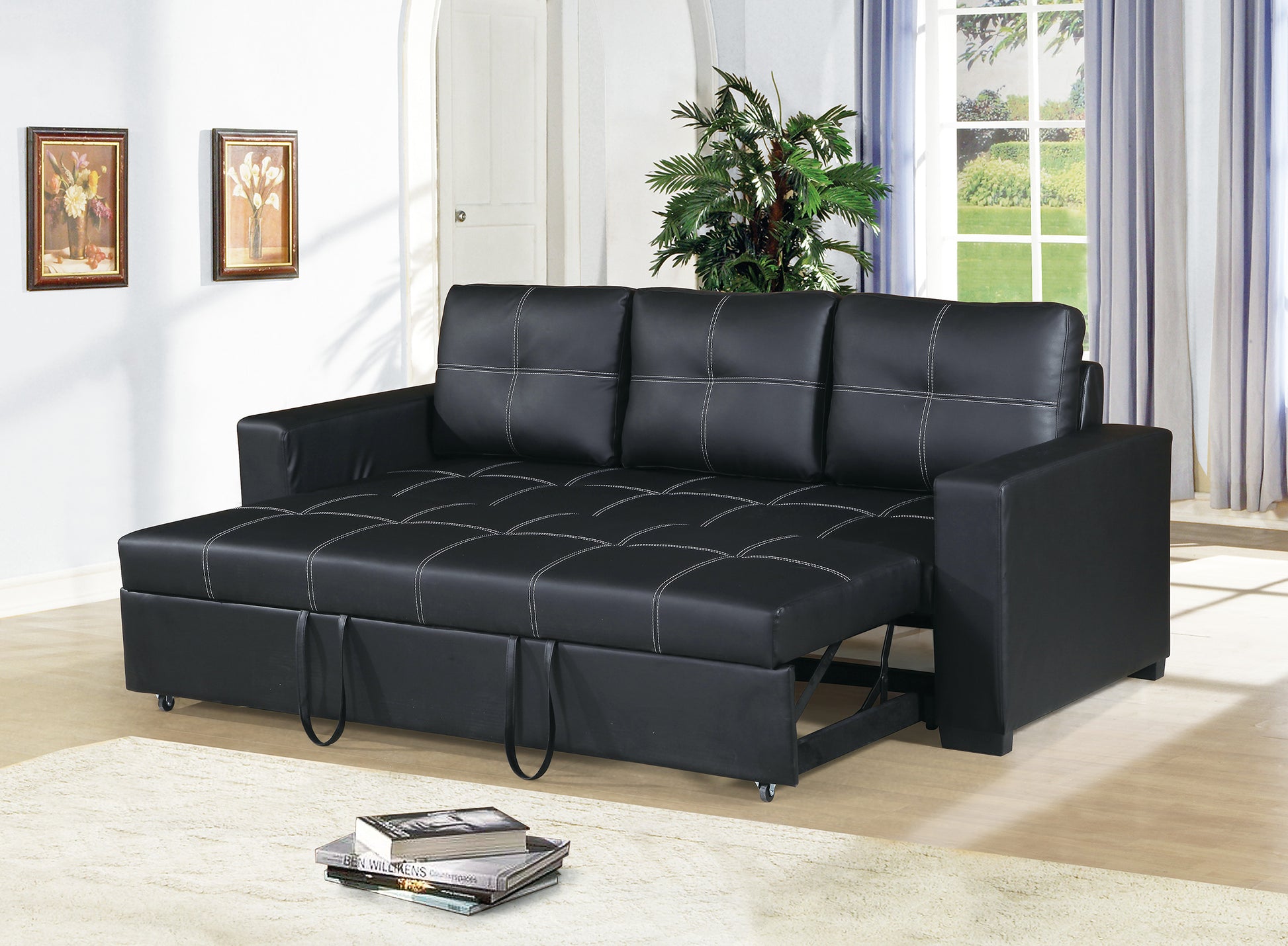Black faux leather sofa bed with white stitching and pullout ottoman function