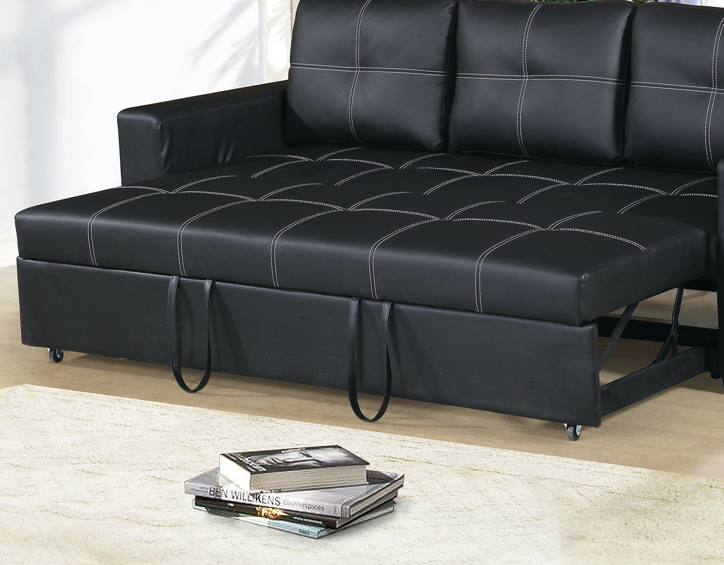 Black faux leather sofa bed with white stitching detail