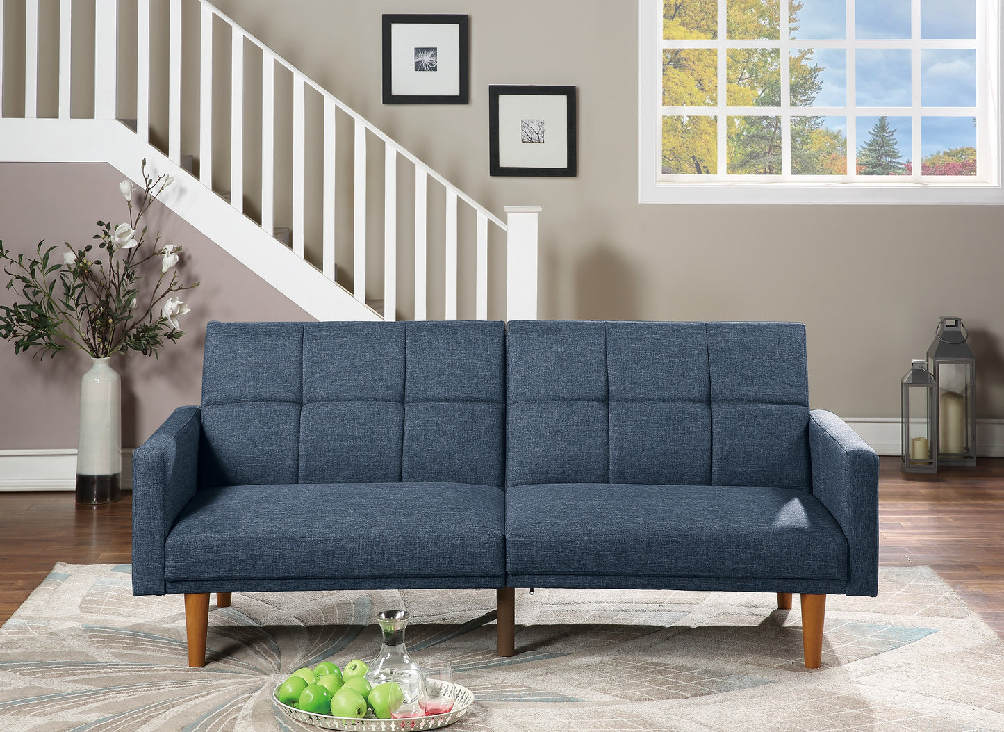 Navy blue fabric sofa with button tufting and wooden legs perfect for modern living rooms