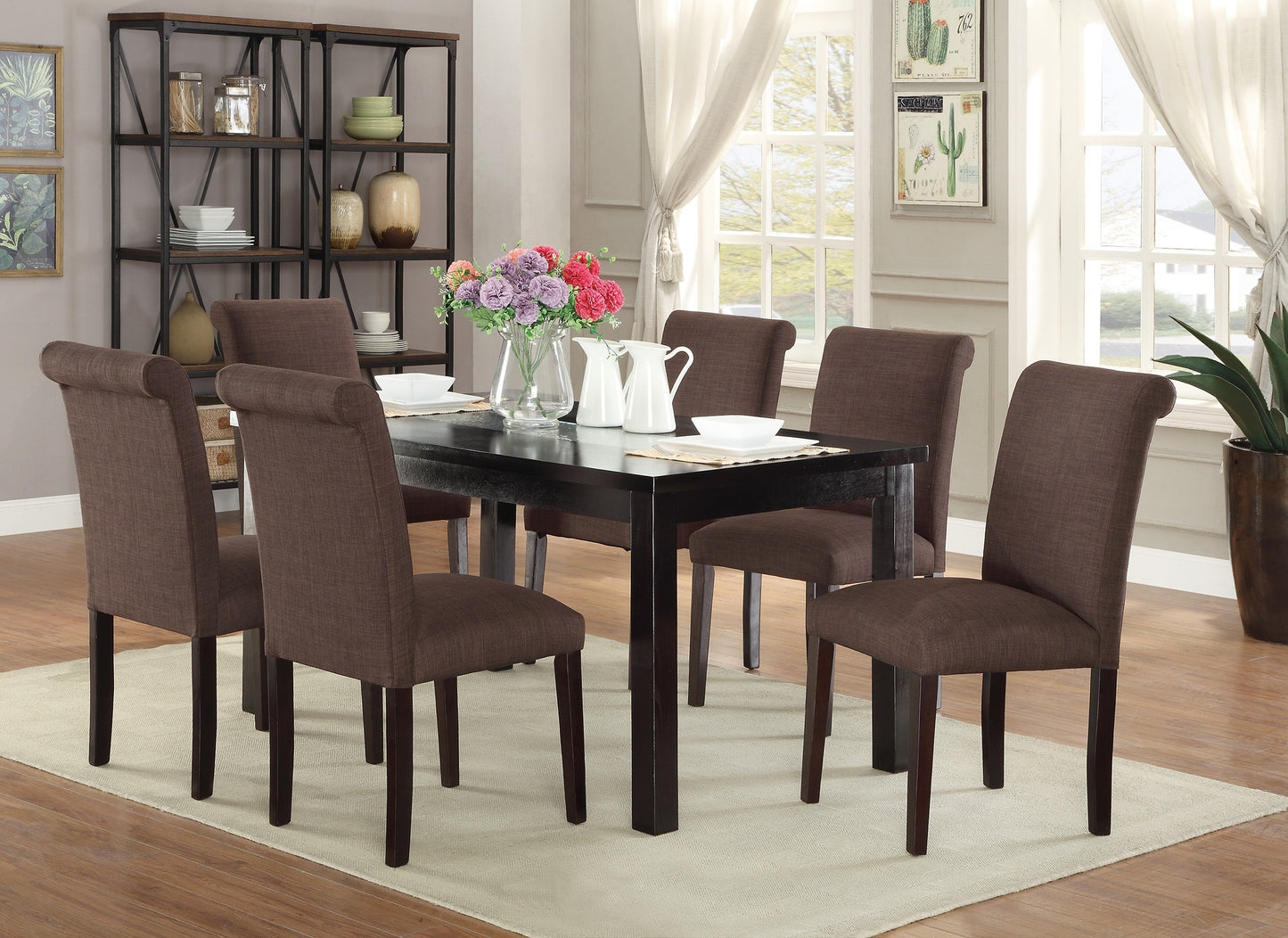Dark brown upholstered dining chairs with rolltop backs surround a dark wood table