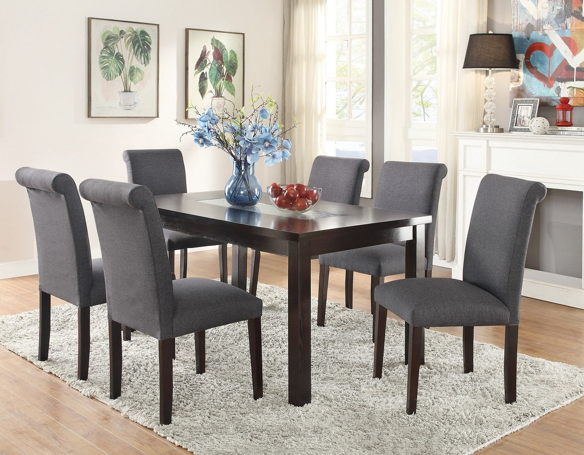 Dark wood dining table with six upholstered charcoal gray chairs and floral centerpiece