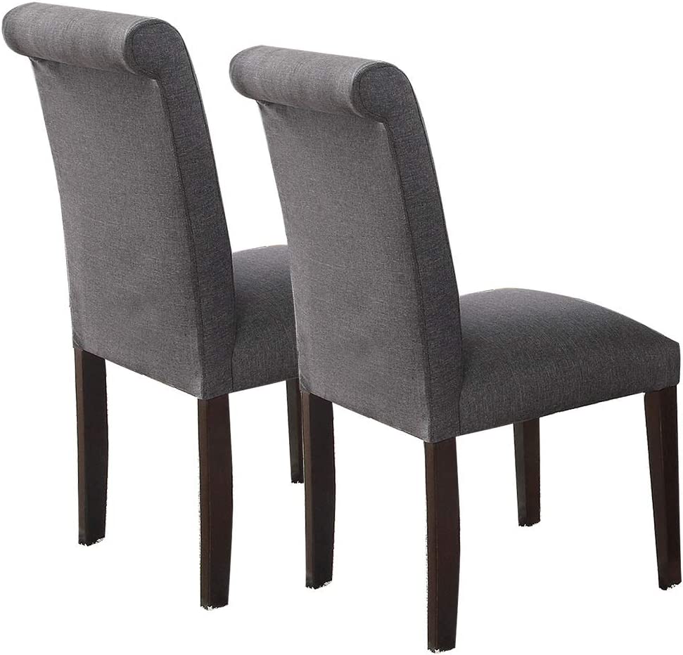Two upholstered dining chairs with dark gray fabric and rolled top backrests