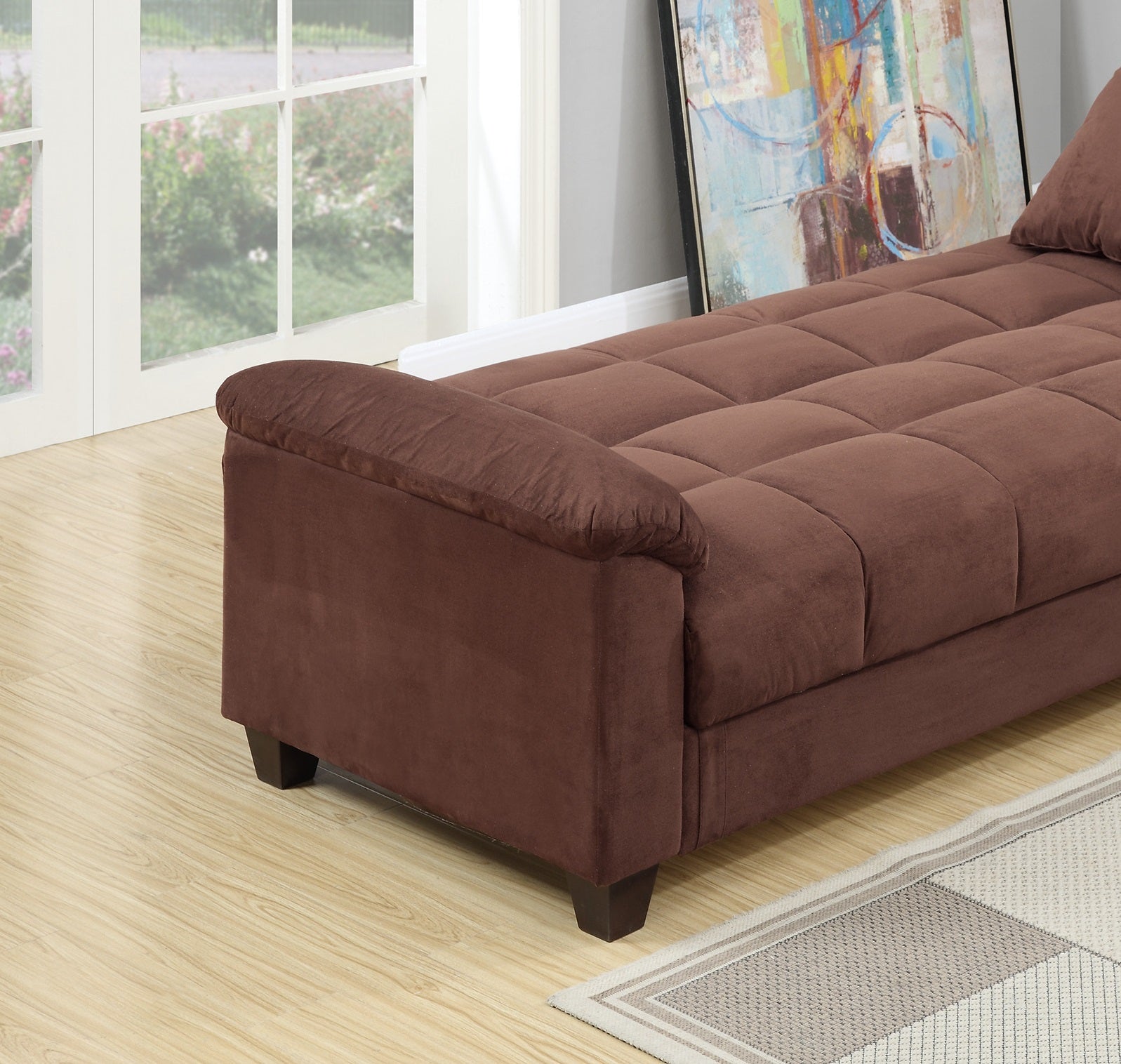 Brown suede tufted sofa with rolled arms and dark wood legs