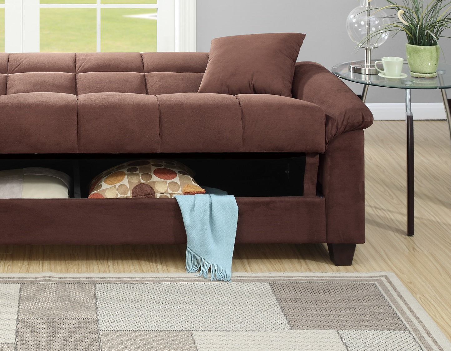 Brown tufted microfiber sofa with hidden storage compartment revealing pillows and a blue throw