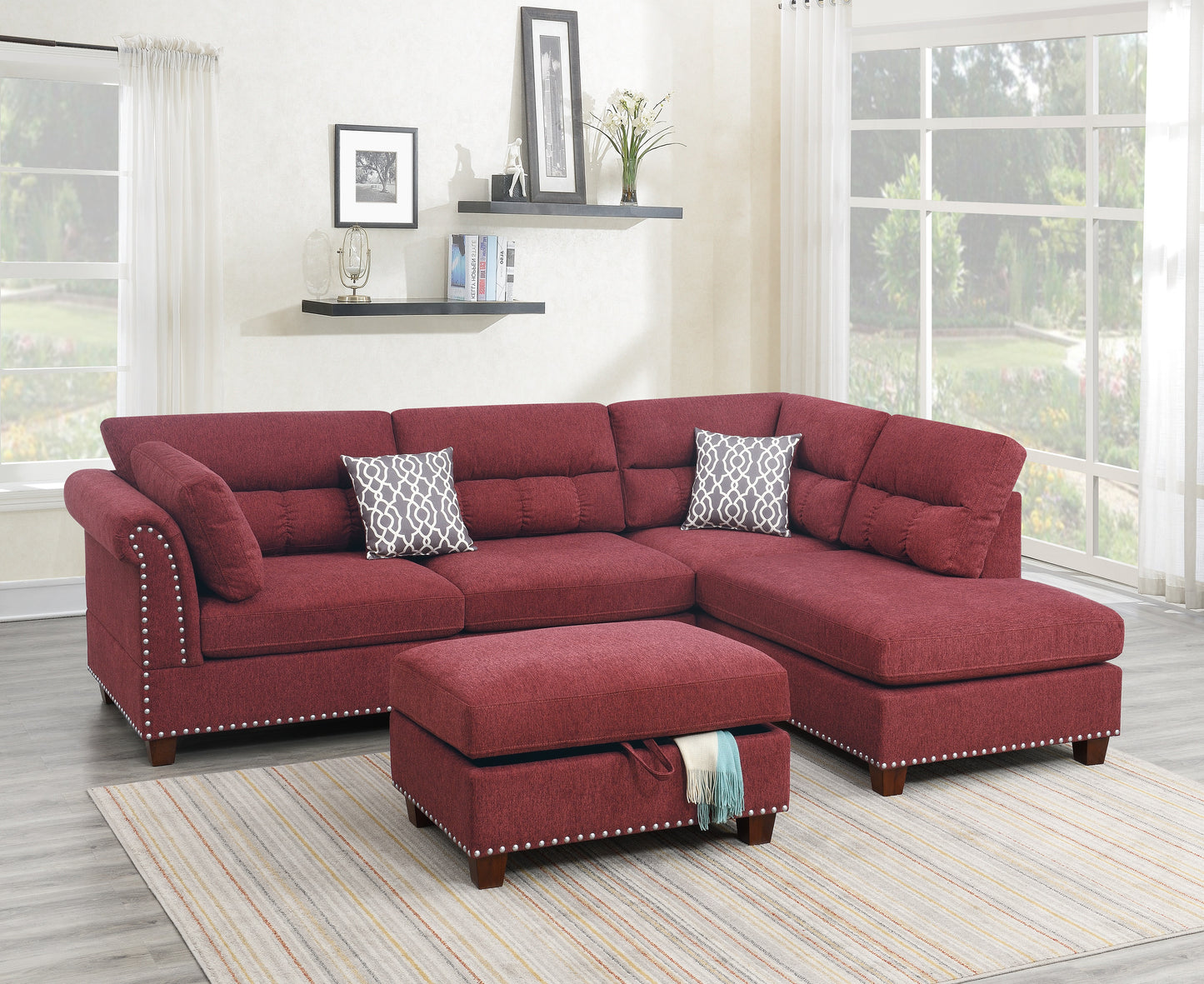 Deep red fabric sectional sofa with nailhead trim and decorative pillows offering a classic style