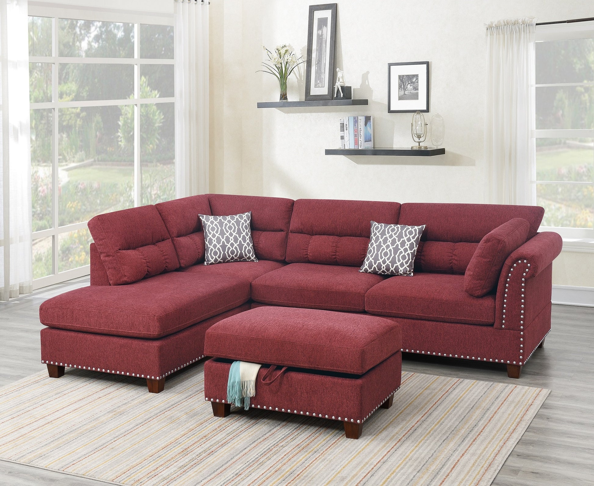 Deep red sectional sofa with decorative nailhead trim and storage ottoman