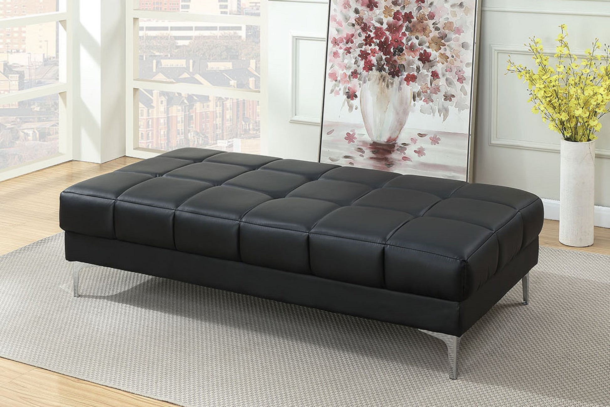 Black tufted leather ottoman with silver metal legs ideal for living rooms
