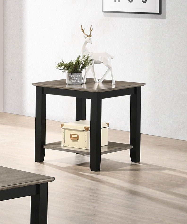 Black and grey accent table with decorative reindeer and plant