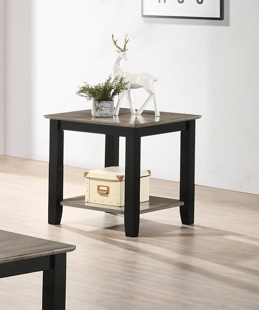 Black and grey accent table with decorative reindeer and plant