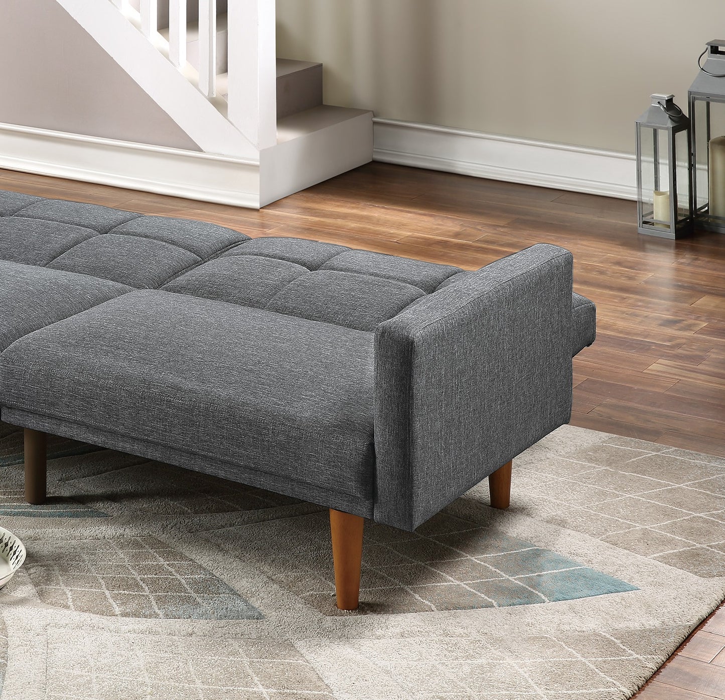 Tufted grey fabric sofa with modern wooden legs ideal for small spaces