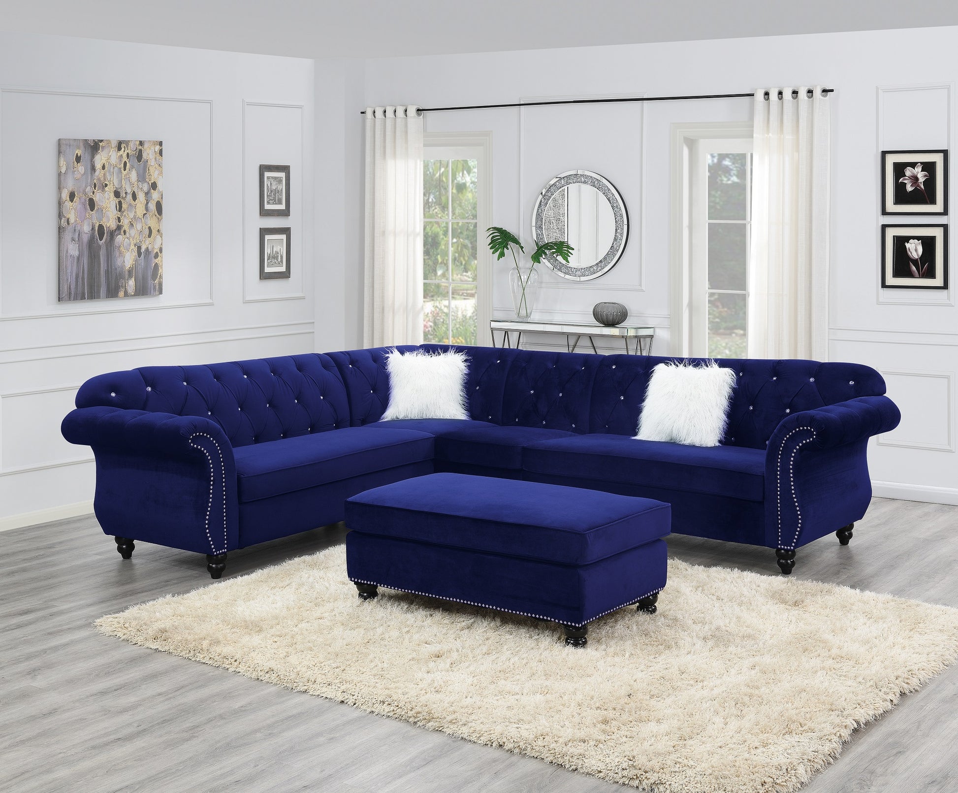 Deep blue velvet sectional sofa with tufted design and silver nailhead trim