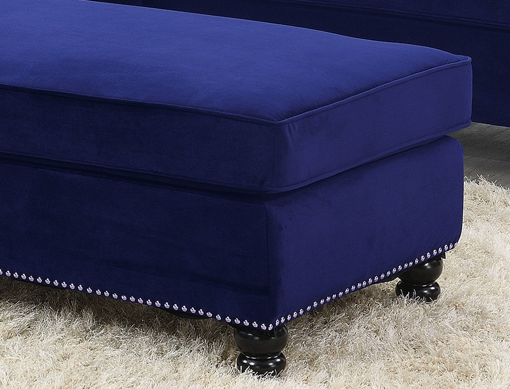 Deep navy velvet ottoman with silver nailhead trim and dark wood legs