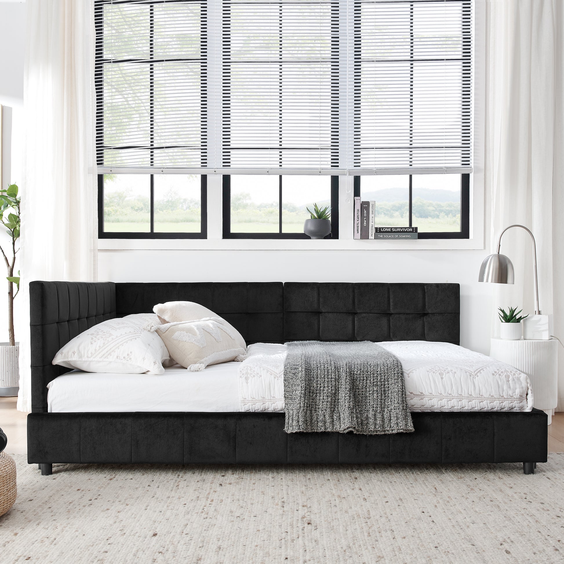 Black velvet tufted bed frame with modern channel design and plush pillows