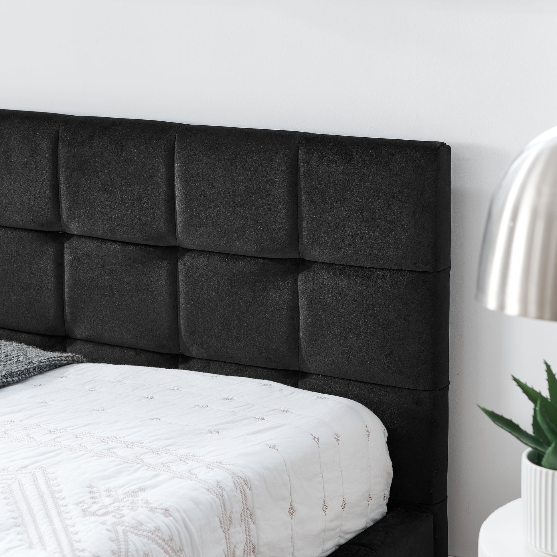 Black velvet upholstered headboard with square tufting