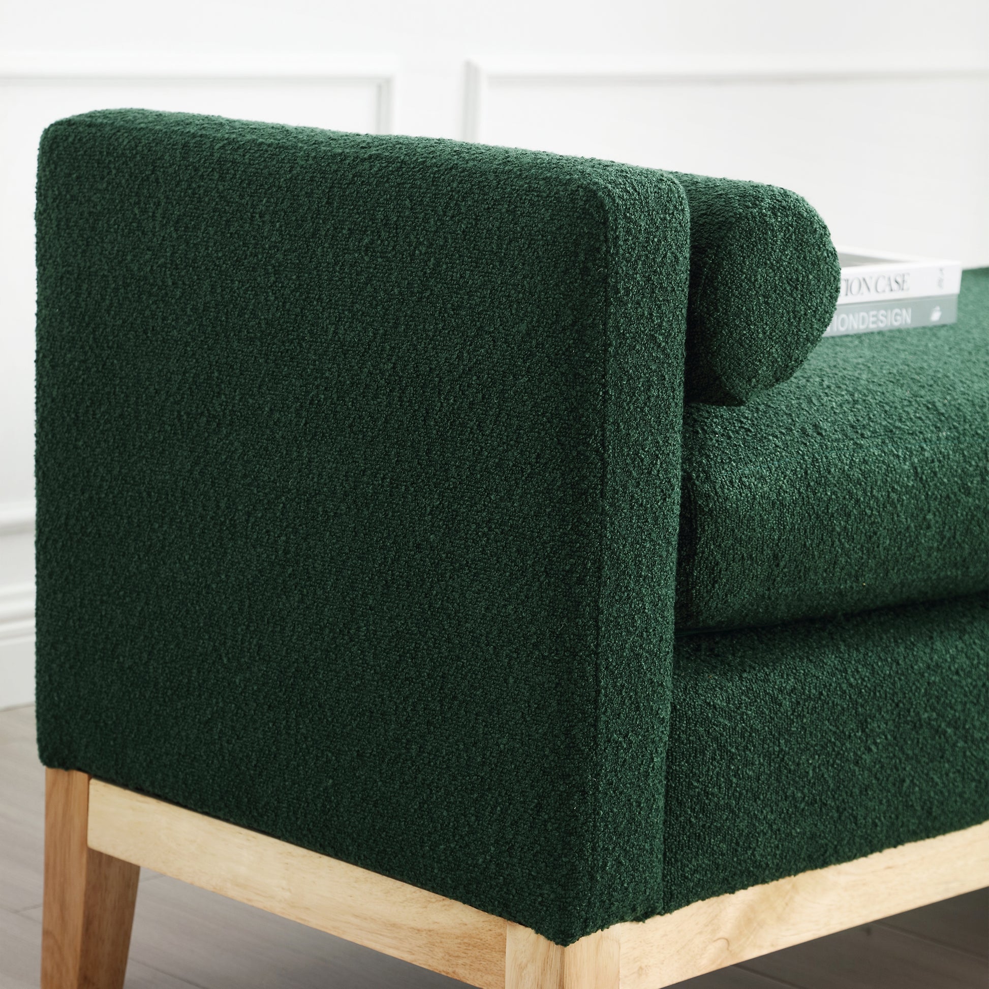 Deep green boucle fabric sofa armrest with light wood legs
