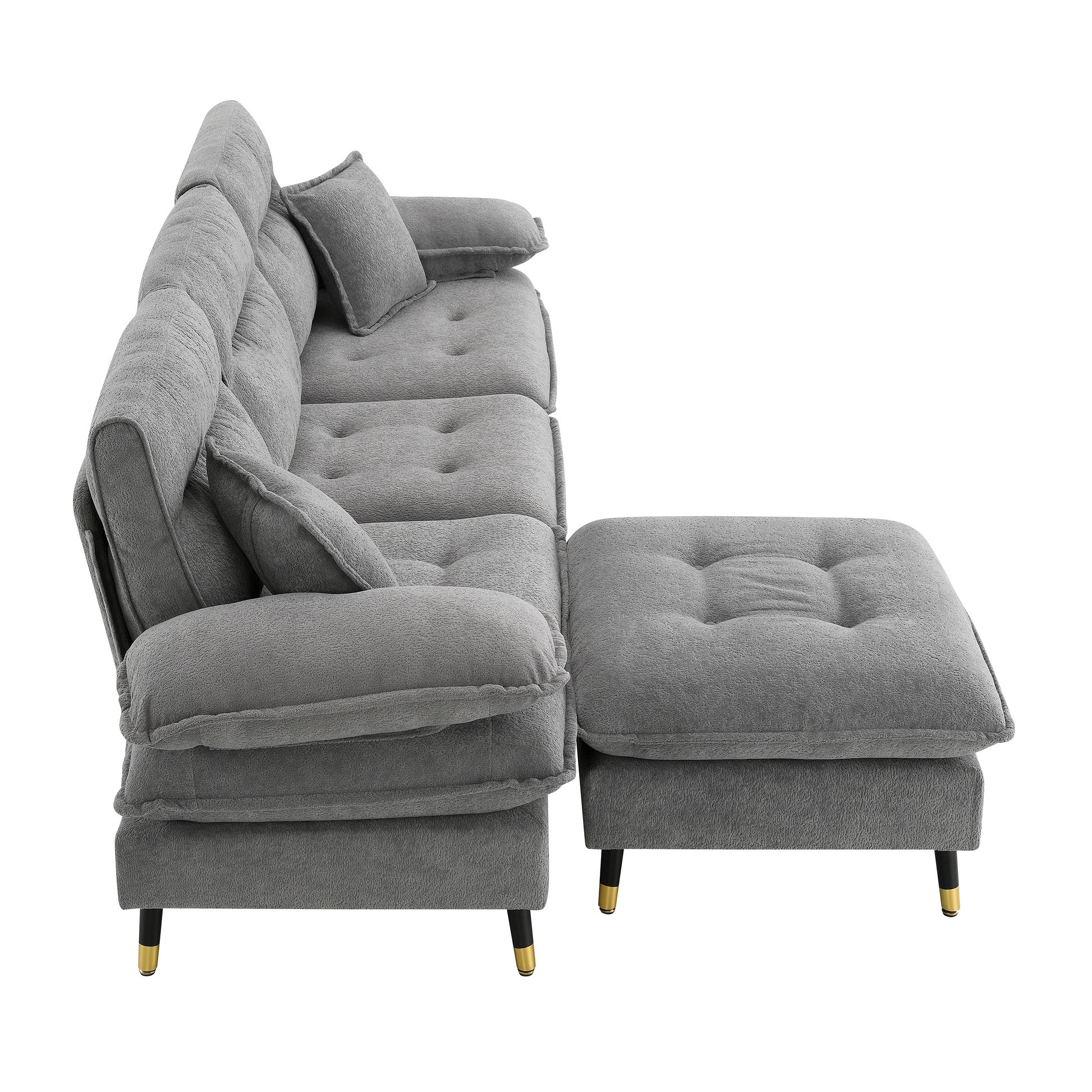 Plush gray sectional sofa with tufted cushions and goldaccented legs featuring a matching ottoman