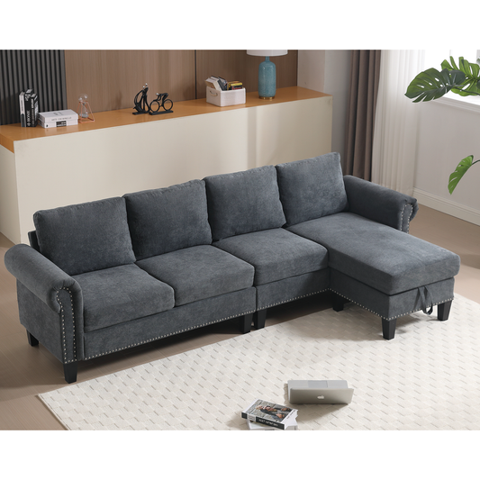 Dark grey fabric sectional sofa with studded trim and chaise lounge