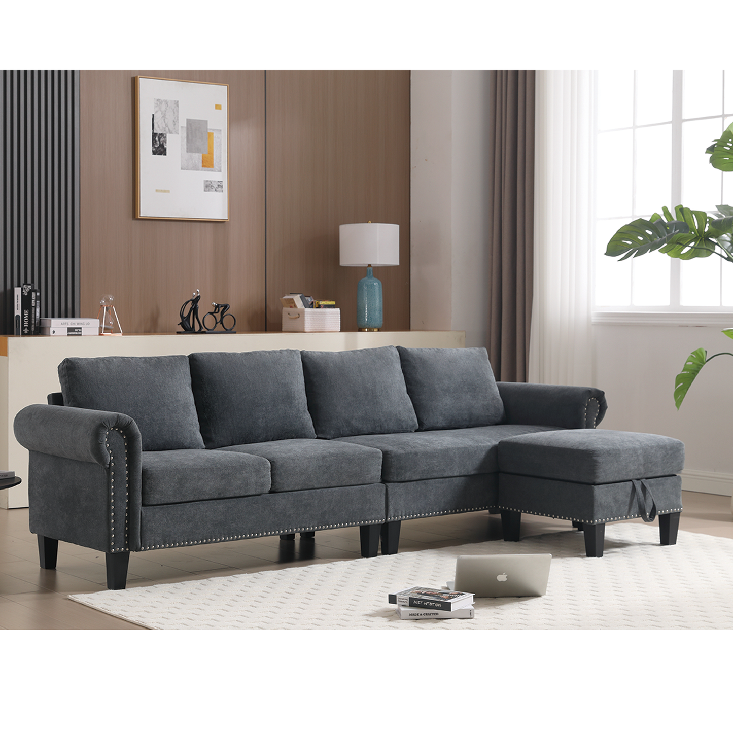 Dark gray sectional sofa with studded arms and a chaise ottoman for living room comfort