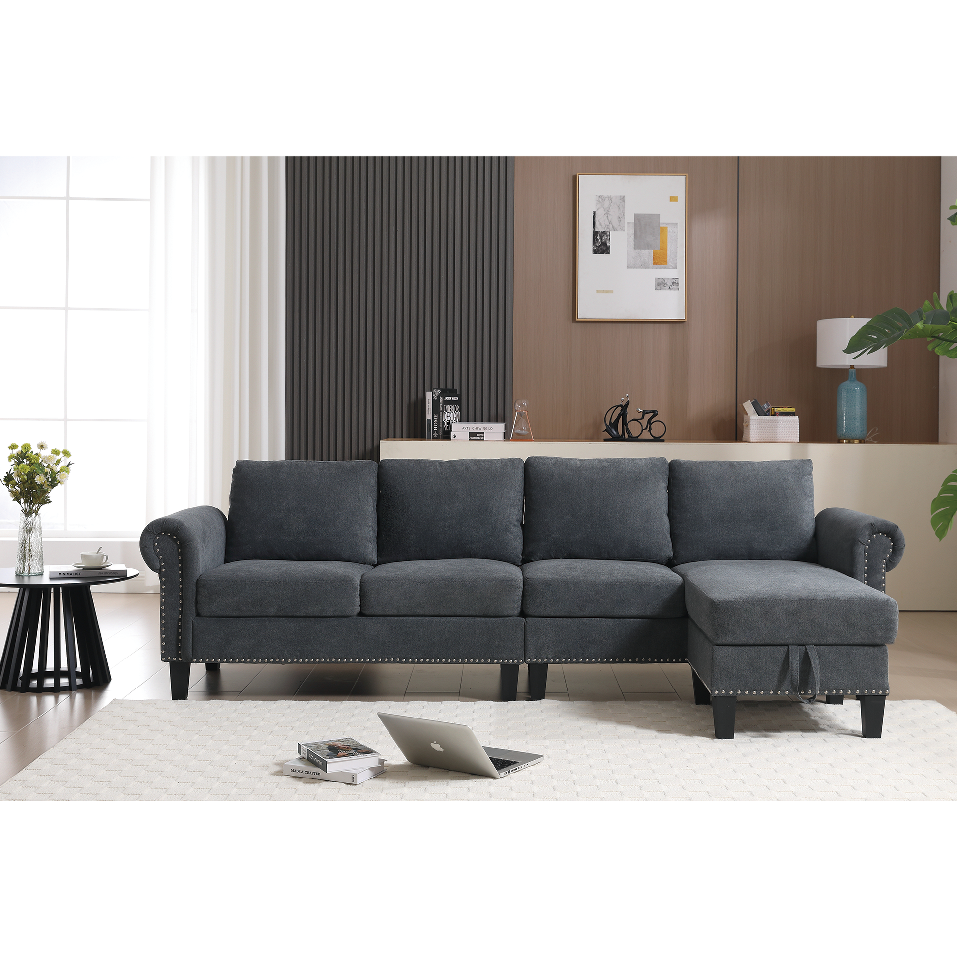 Dark gray fabric sectional sofa with nailhead trim and chaise lounge