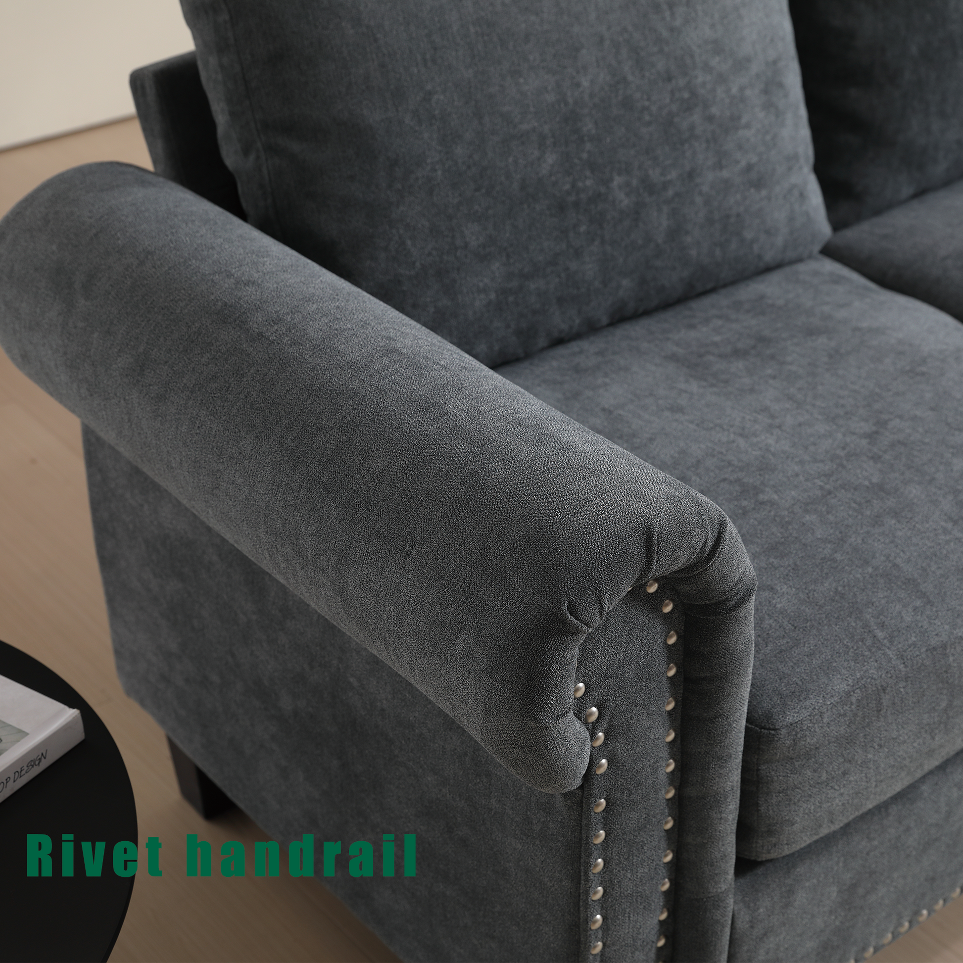 Dark grey fabric sofa with rolled arms and decorative nailhead trim