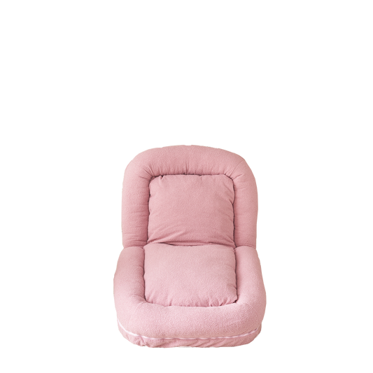 Soft pink boucle floor chair with plush cushioning and lumbar support