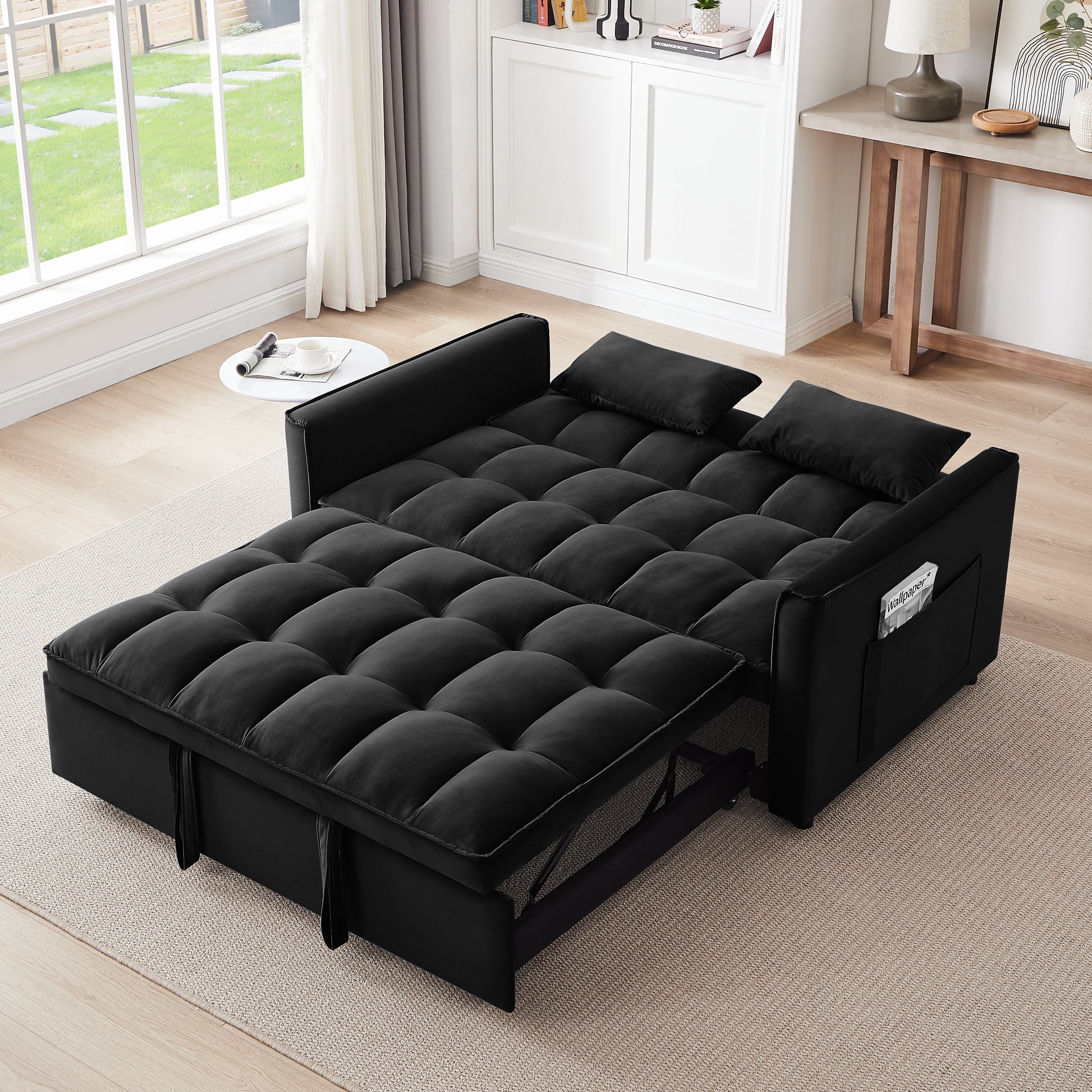 Black velvet sofa bed with tufted cushions and pullout mattress for versatile seating
