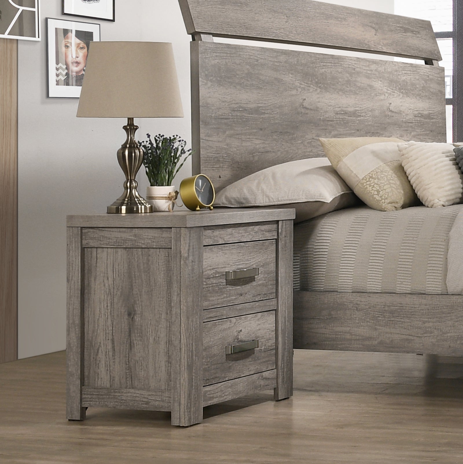 Distressed gray wood nightstand with two drawers and metal pulls beside a bed