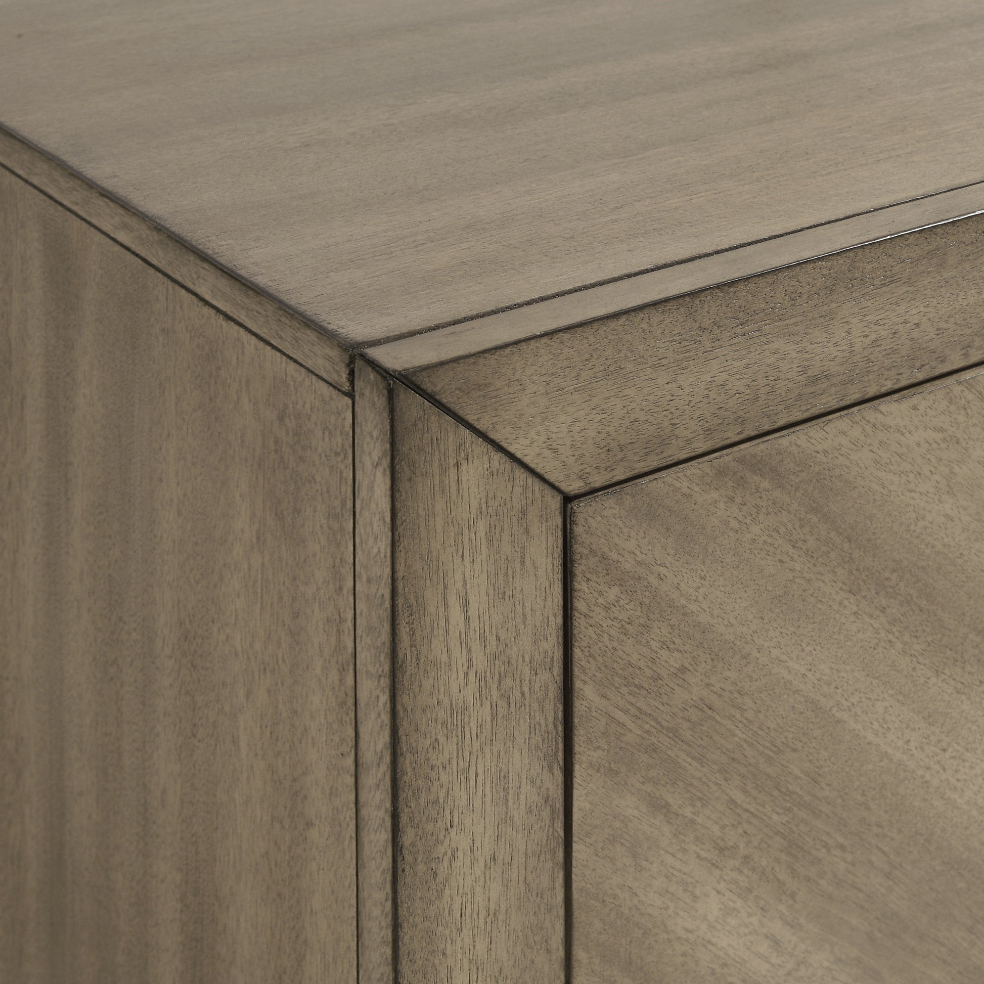 Closeup of grey wood grain on a contemporary cabinet corner highlighting texture and modern design