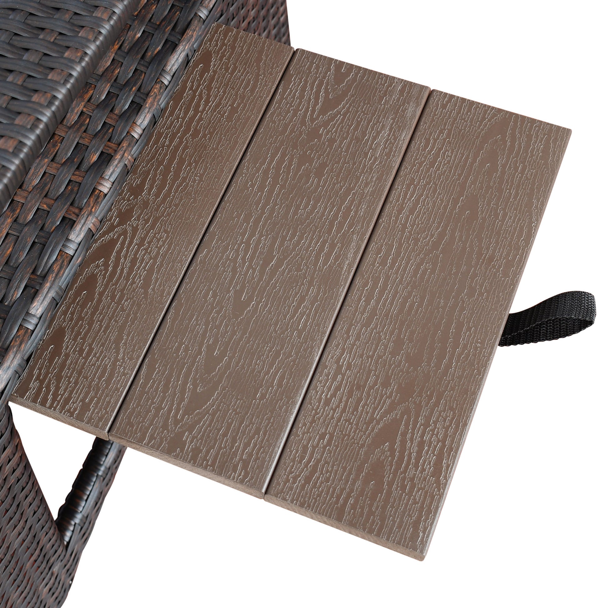 Dark brown wicker patio chair armrest with textured woodgrain side table