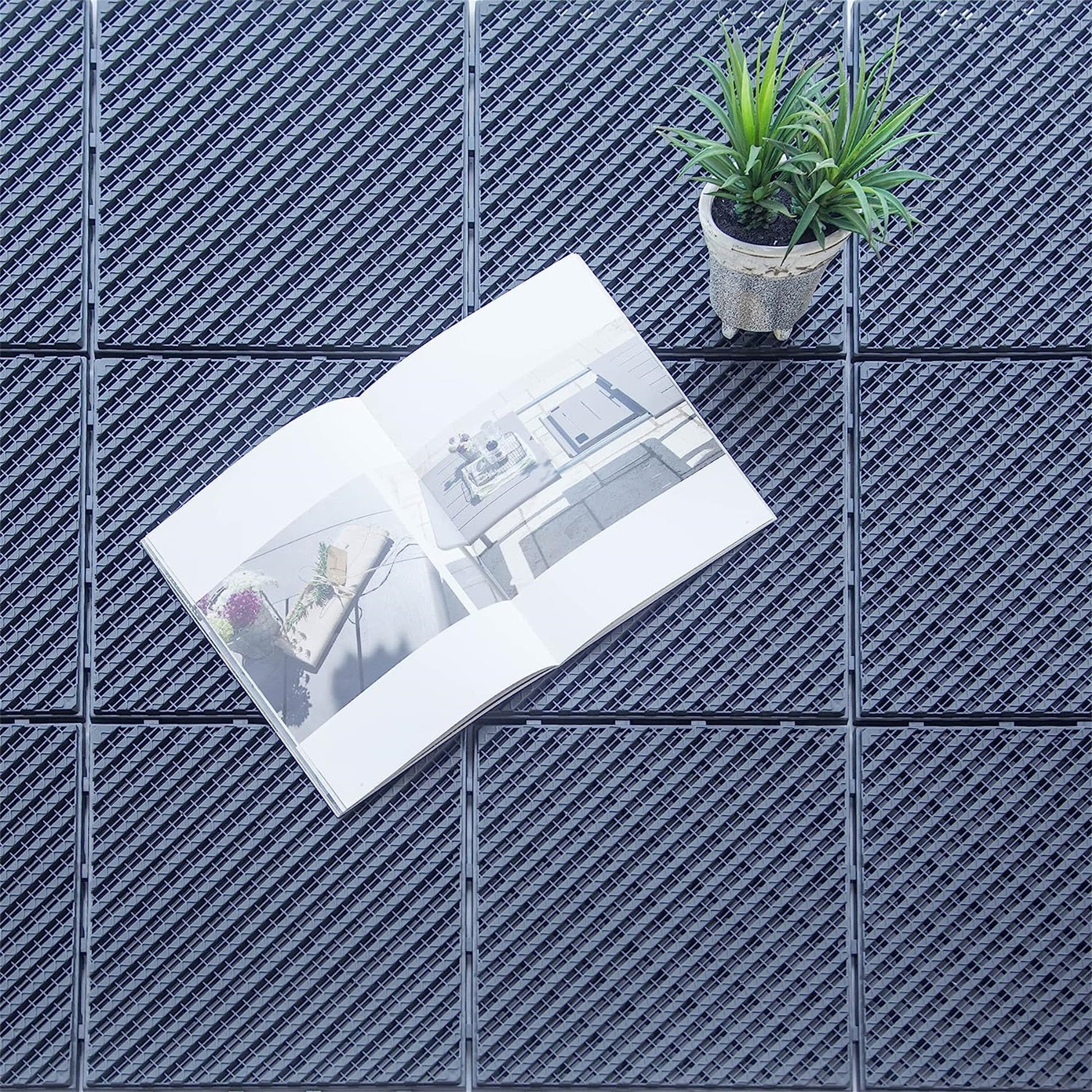 Gray interlocking deck tiles with a woven texture suitable for outdoor patios