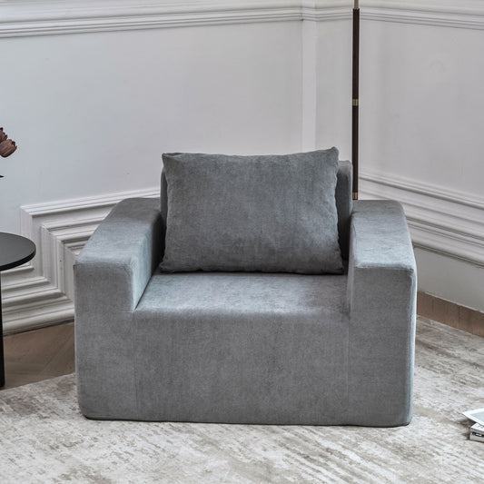 Modern grey fabric armchair with plush throw pillow for living room comfort